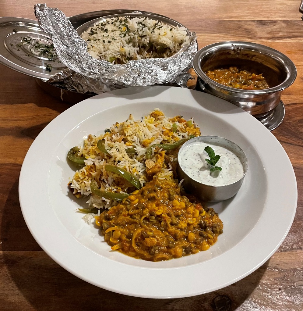 Layered Biryani served with Dal and Raita